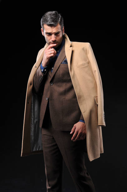 istock Businessman posing with suite on black background 643598978