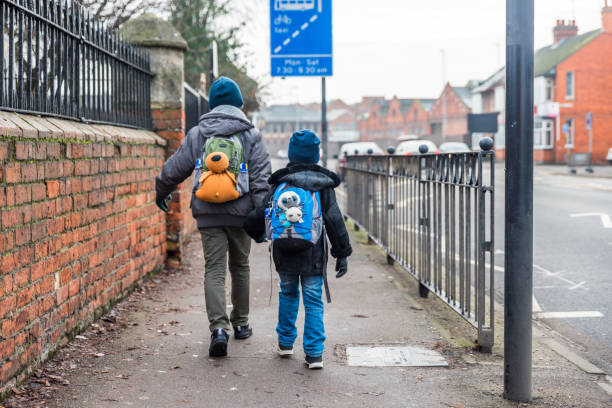 istock Travel concept of two boys with backpacks going forward 643617048