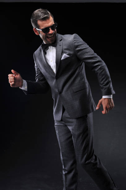 istock Businessman posing with suite on black background 643623344