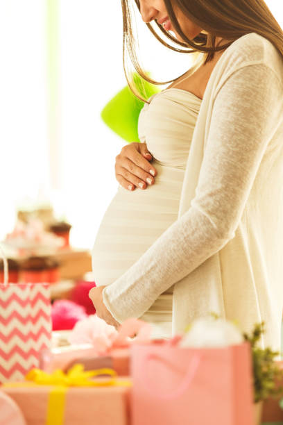 istock Pregnant woman with presents 643625270