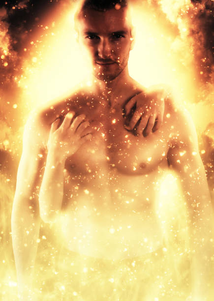 istock Muscular young man embraced by a woman over a fire background 643625688