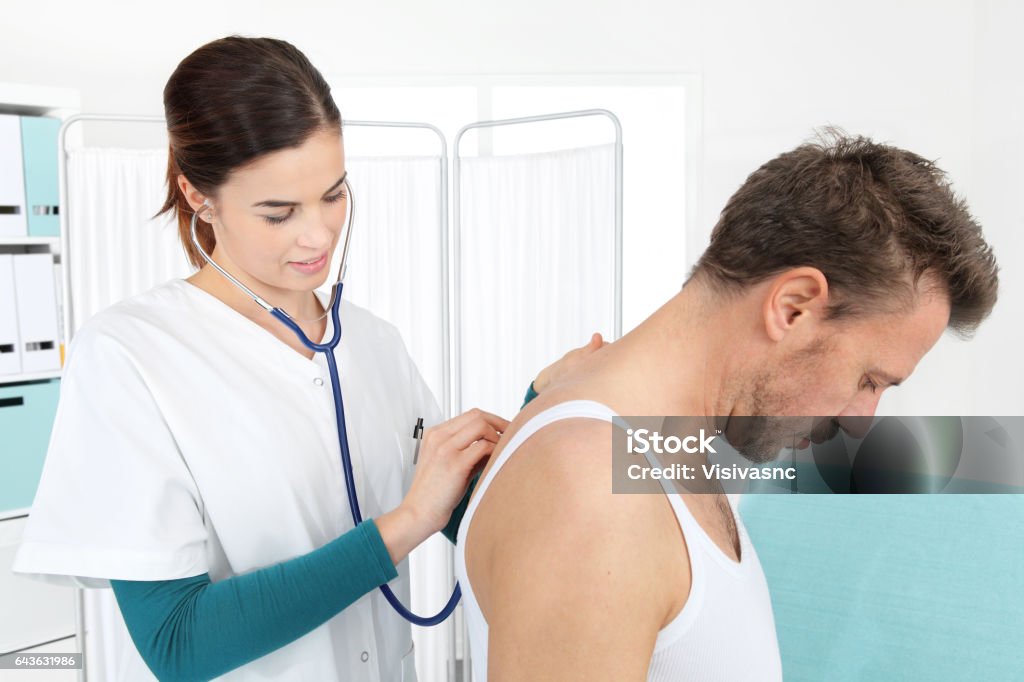 Doctor examining patient with stethoscope in medical office Lung Stock Photo