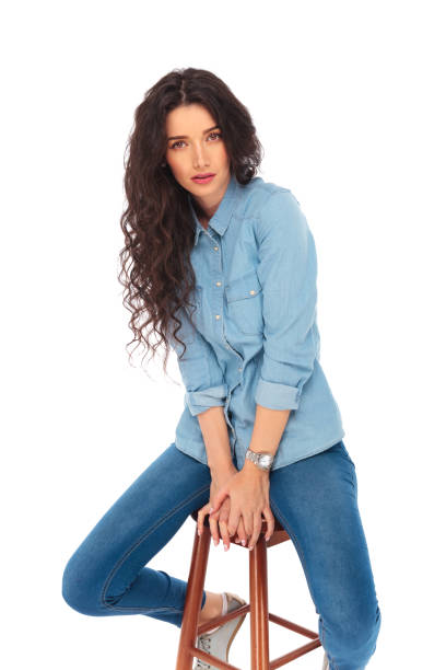 istock serious casual young woman posing while sitting 643632862