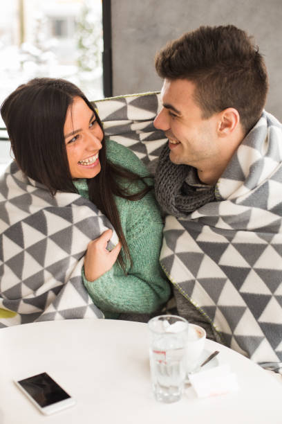 istock Couple wrapped in blanket smiling 643651020