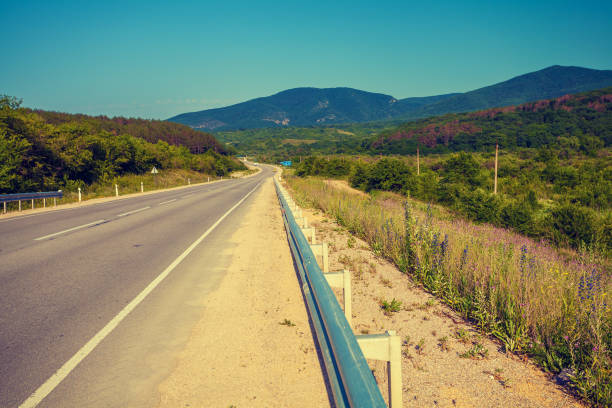 istock Driving a car on mountain road 643651082