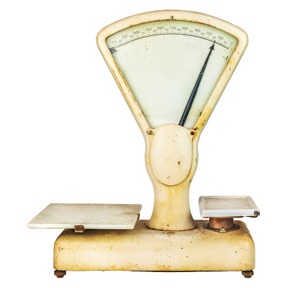 Vintage weathered weighing scale isolated on a white background