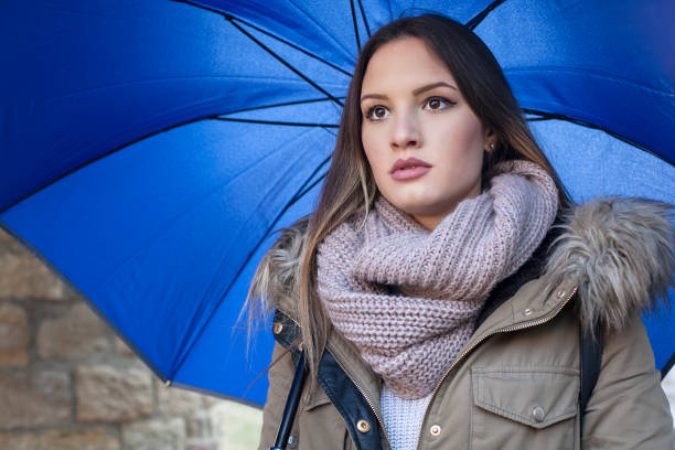 istock Young woman with umbrella 643659858