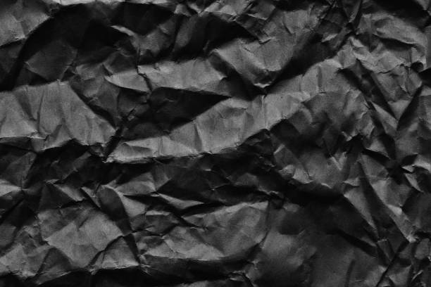 istock Black crumpled paper background and texture 643659966