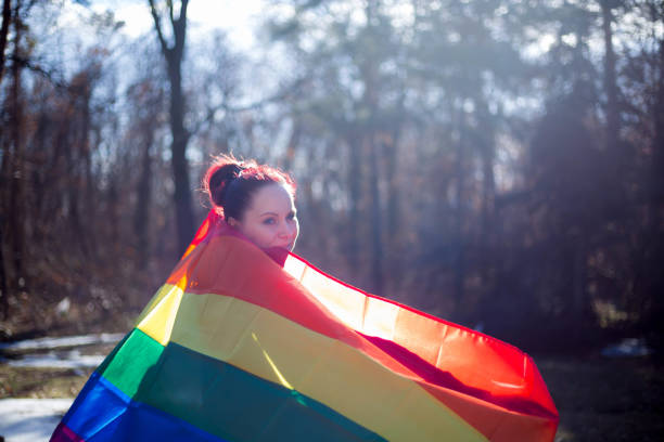 istock female is holding the gay rainbow flag 643662458