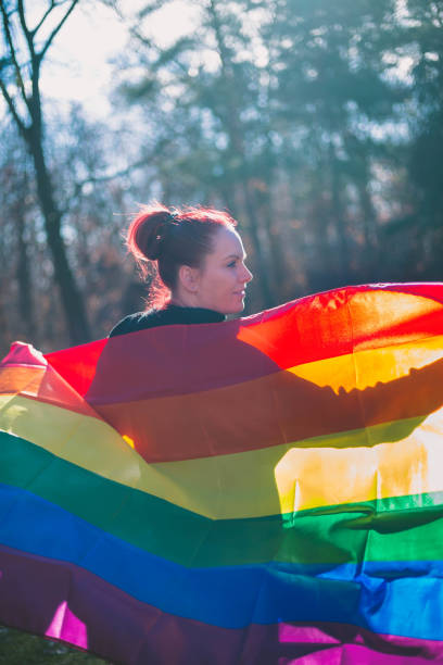 istock female is holding the gay rainbow flag 643662662