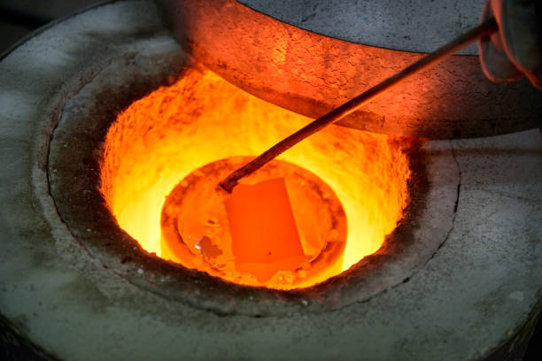 istock horizontal Bronze metal alloy bars melting in oven for casting 643662942