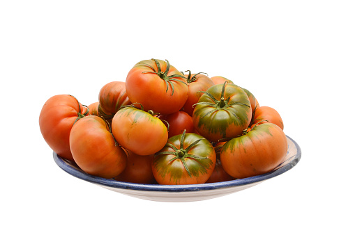 Raff tomatoes on plate isolated on white background