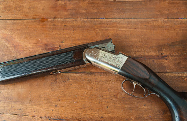 istock hunting gun on wooden background 643669716