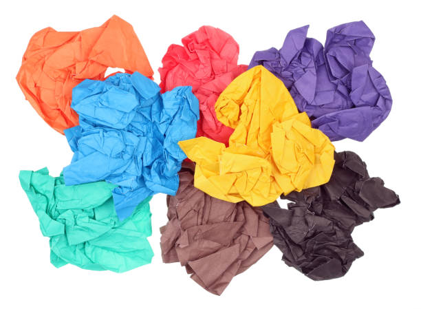 istock The crumpled  paper sheets of different colors lie on a white table. Isolated 643669814