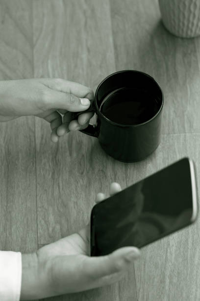 istock Businesswoman drinking coffee and using smart phone 643672930