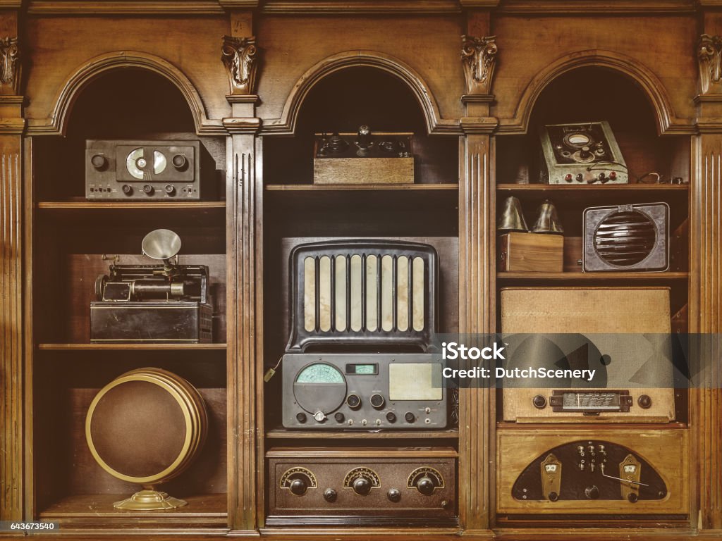 Sepia toned image of old radio's Sepia toned image of old radio's in a wooden cabinet 1950-1959 Stock Photo