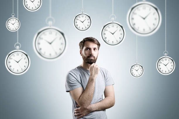 istock Bearded man and pocket watches, gray wall 643680118