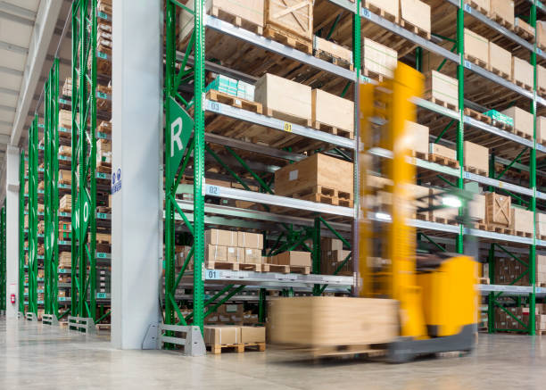 istock Forklift carrying cardboard box in warehouse 643685380