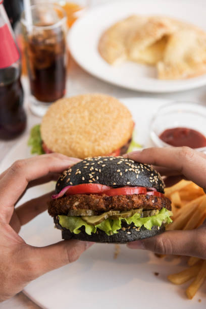 istock Man eating burgers 643685902