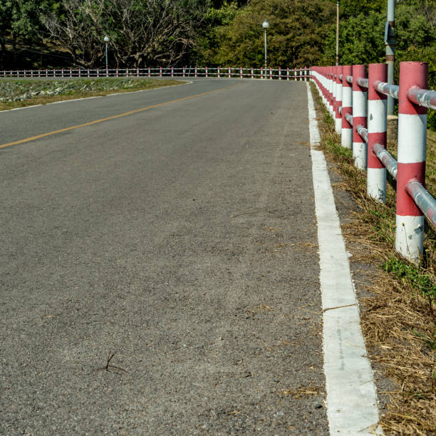 istock Asphalt road with red and white fence 643686128