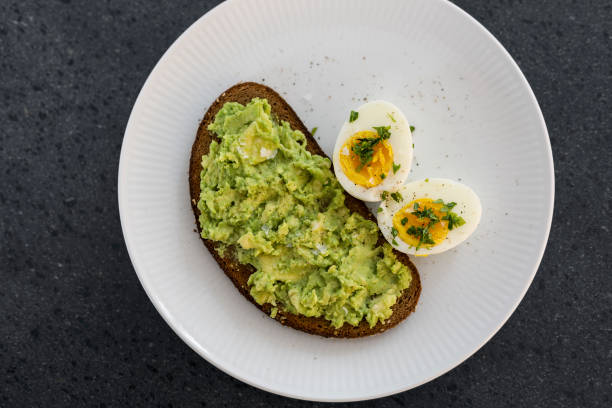 Breakfast with avocado and eggs stock photo