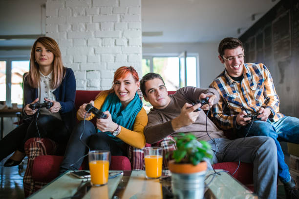 istock Group of friends playing digital games at home. 643687800