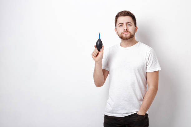 istock photographer holding camera cleaning vacuum pump.  air blower pu 643687830