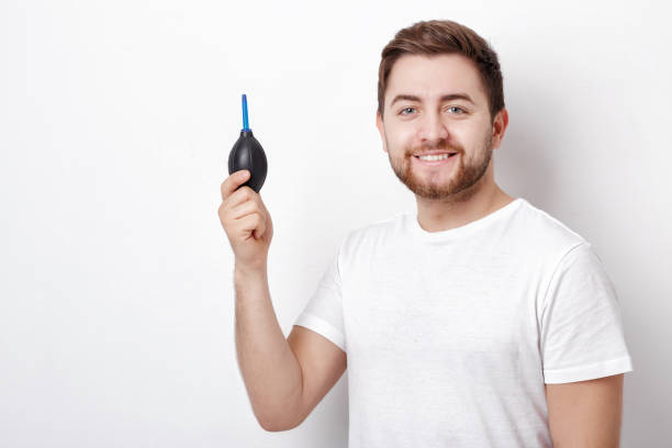 istock photographer holding camera cleaning vacuum pump.  air blower pu 643689968