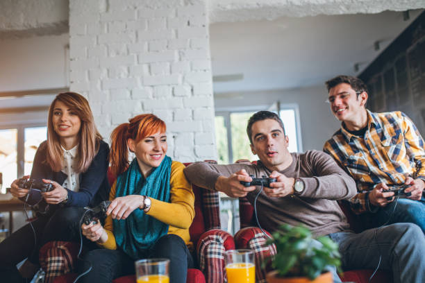 istock Group of friends playing digital games at home. 643690148