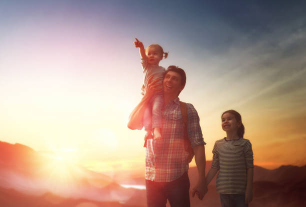istock Father and two children at sunset 643693480