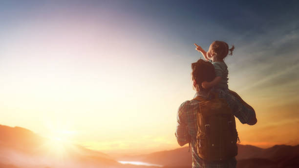 istock Kid and dad look at sunset 643693576