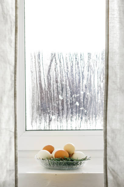 istock chicken eggs in a glass bowl green branches 643699222