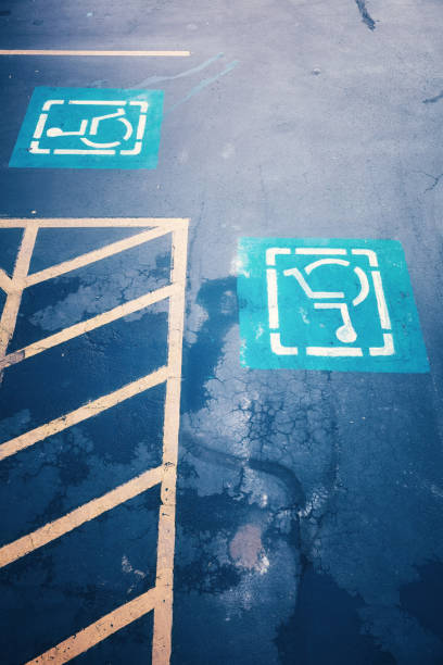 istock Disabled parking road signs, color toned picture. 643699626