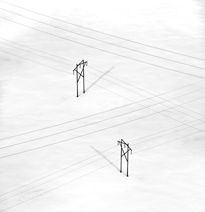Rural power lines cross a vast field under a deep blanket of snow covering Nova Scotia in February 2017.