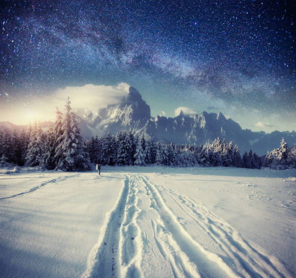 istock starry sky in winter snowy night. fantastic milky way 643710818