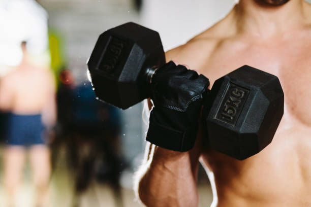 istock athletic male with dumbbells workout 643710970