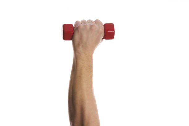 istock Man's  hand holding dumbbell isolated on white background 643724492