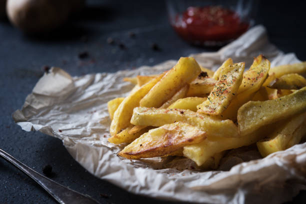 istock French fries on dark background 643724894