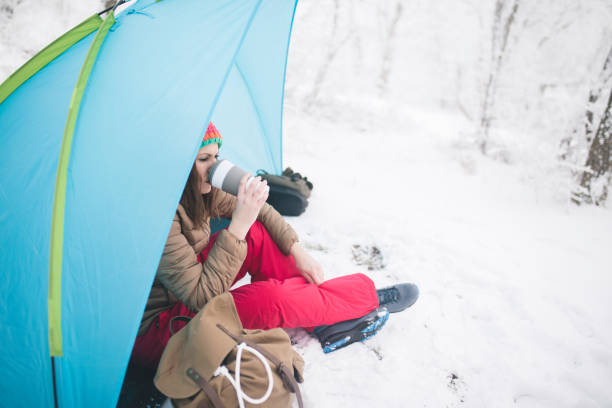 istock Woman inside tent set in winter hiking 643727434