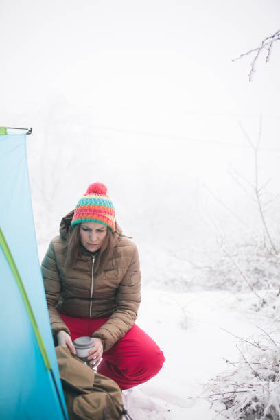 istock Woman inside tent set in winter hiking 643727572