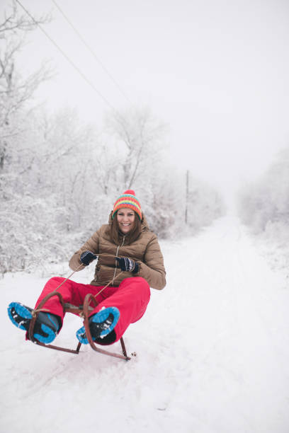 istock young woman sledging in deep snow and have fun 643734572