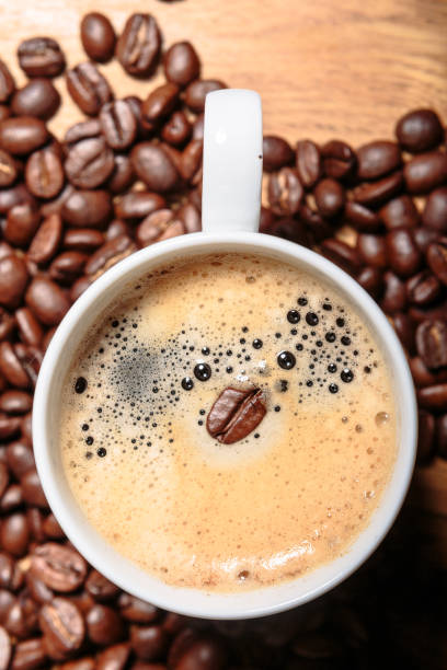 istock Coffee Cup with Coffee Bean in it over Coffee Beans. Top View. 643744044