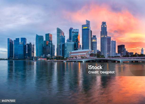 The Singapore Downtown And Marina Bay Business District Skyline At Twilight With Sunset Illuminating The Clouds And Sky Stock Photo - Download Image Now