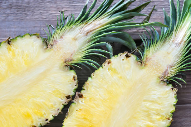 istock Pineapple on the wooden background: cross section 643747990