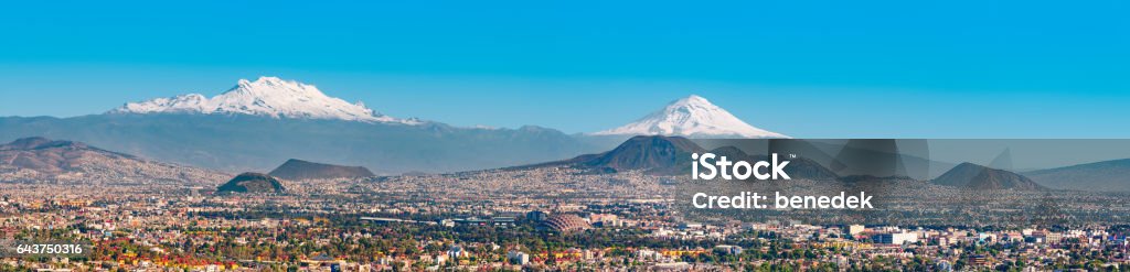 Iztaccihuatl and Popocatepetl volcanoes and Mexico City Panoramic stock photo of the snow covered Iztaccihuatl aka Ixtaccihuatl (left) and Popocatepetl (right) volcanic mountains with Mexico City at their feet as seen from Mexico City, Mexico. Mexico City Stock Photo