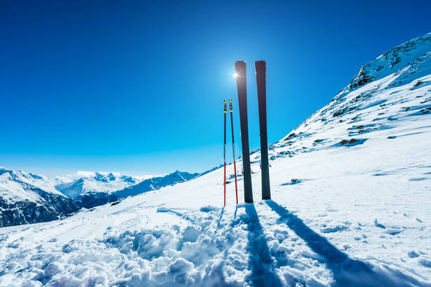 Skis and ski poles on remote slope of ski resort.