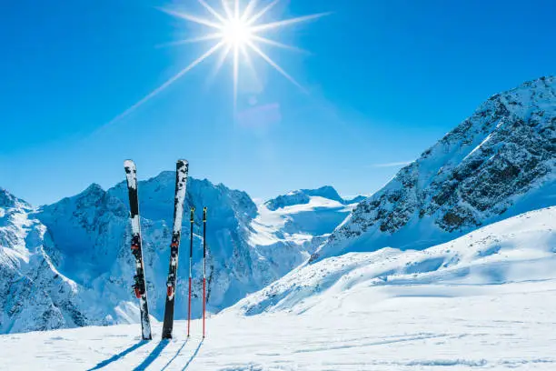 Skis and ski poles on remote slope of ski resort.