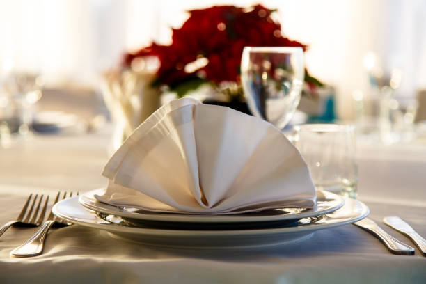 istock Linen napkin on a plate on the table covered with a white tablecloth. 643753722