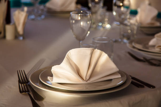 istock Linen napkin on a plate on the table covered with a white tablecloth. 643753740