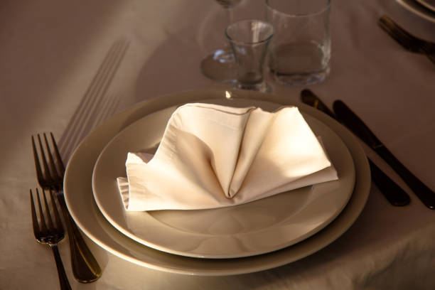 istock Linen napkin on a plate on the table covered with a white tablecloth. 643753744